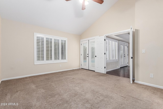 unfurnished bedroom with ceiling fan, carpet floors, high vaulted ceiling, and french doors