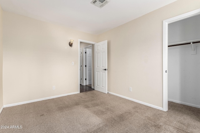 unfurnished bedroom featuring a closet and carpet floors