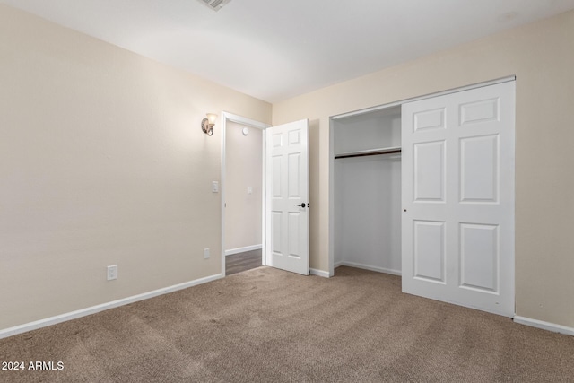 unfurnished bedroom with carpet and a closet