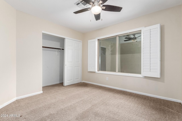 unfurnished bedroom with ceiling fan, a closet, and light colored carpet