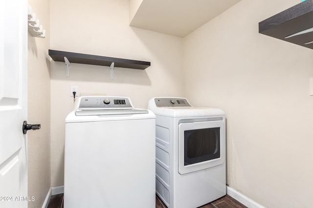 laundry room with separate washer and dryer and dark hardwood / wood-style flooring