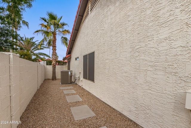 view of side of home with central AC unit