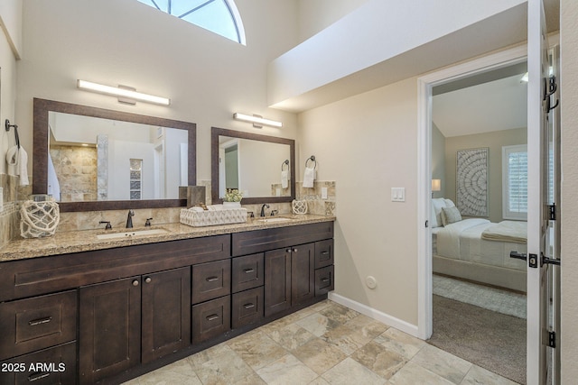 11085 E Becker Ln E, Scottsdale, AZ 85259 - ensuite bathroom featuring double vanity, plenty of natural light, tasteful backsplash, and a high ceiling