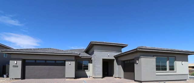 prairie-style house featuring a garage