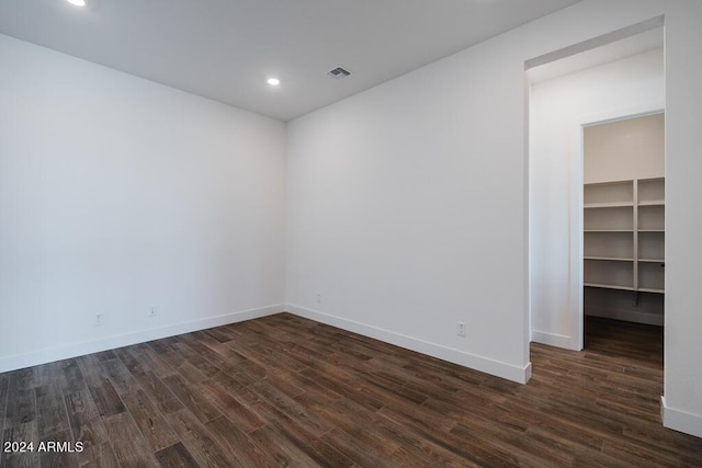 empty room with dark wood-type flooring