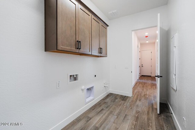 washroom featuring cabinets, hookup for a gas dryer, electric dryer hookup, hardwood / wood-style floors, and washer hookup