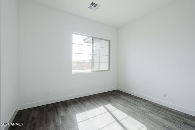 spare room with dark hardwood / wood-style floors