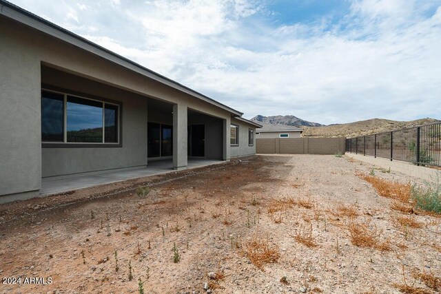 view of yard featuring a mountain view and a patio area