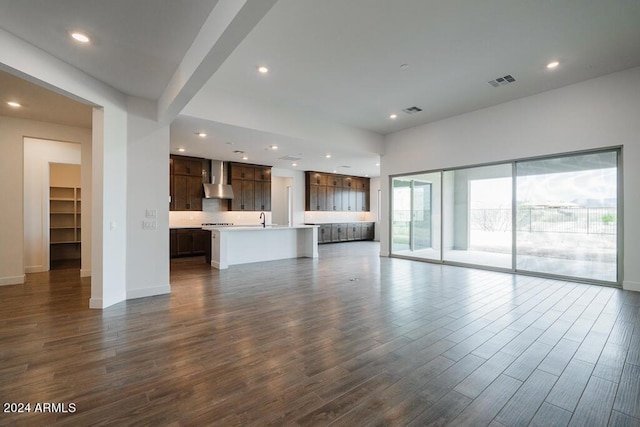 unfurnished living room with sink and dark hardwood / wood-style floors