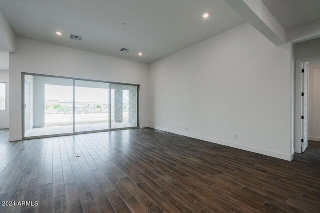 unfurnished room with dark hardwood / wood-style floors