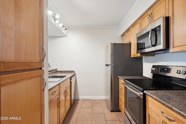 3314 N 68th St Unit 129, Scottsdale, AZ 85251 - kitchen featuring stainless steel appliances, crown molding, dark countertops, and light tile patterned flooring