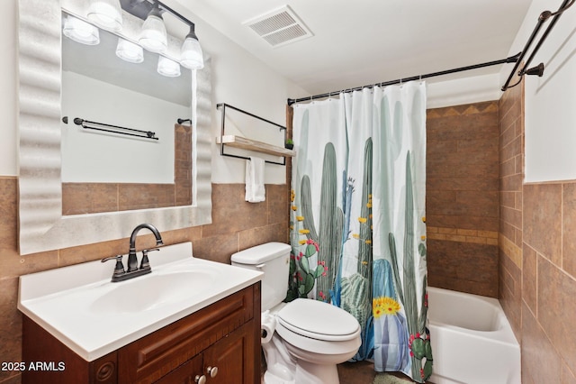 3314 N 68th St Unit 129, Scottsdale, AZ 85251 - bathroom featuring tile walls, vanity, shower / tub combo, and wainscoting