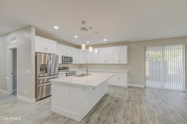 5945 W Lamar Rd, Glendale, AZ 85301 - kitchen featuring stainless steel appliances, a sink, baseboards, light wood finished floors, and recessed lighting