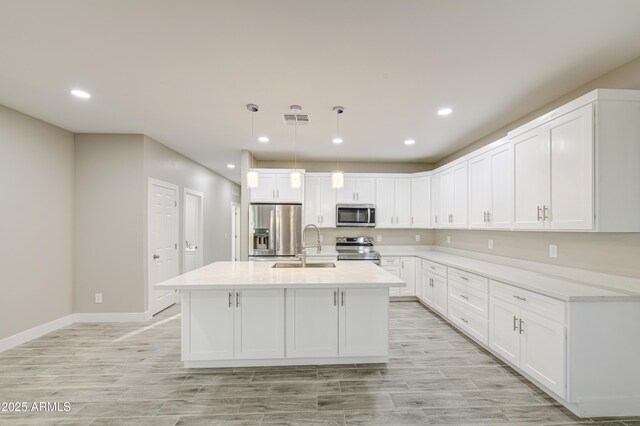 5945 W Lamar Rd, Glendale, AZ 85301 - kitchen with stainless steel appliances, white cabinetry, light countertops, a kitchen island with sink, and recessed lighting