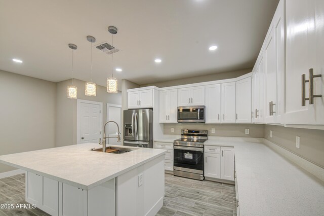 5945 W Lamar Rd, Glendale, AZ 85301 - kitchen with stainless steel appliances, a sink, light wood finished floors, light countertops, and white cabinets