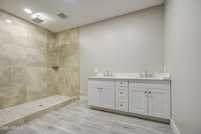 5945 W Lamar Rd, Glendale, AZ 85301 - bathroom featuring tiled shower, double vanity, and baseboards