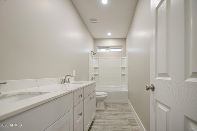 5945 W Lamar Rd, Glendale, AZ 85301 - bathroom with toilet, double vanity, baseboards,  shower combination, and recessed lighting