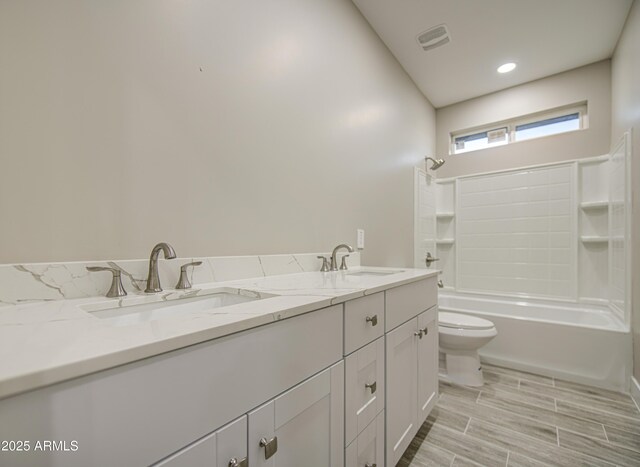 5945 W Lamar Rd, Glendale, AZ 85301 - bathroom featuring double vanity, toilet, and shower / bathtub combination