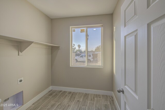 5945 W Lamar Rd, Glendale, AZ 85301 - laundry room with baseboards, electric dryer hookup, and wood tiled floors