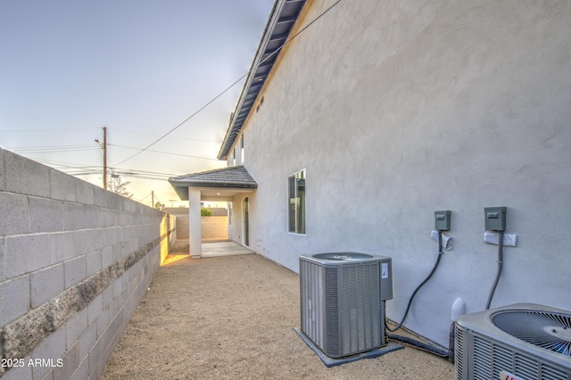 5945 W Lamar Rd, Glendale, AZ 85301 - view of property exterior with central air condition unit, stucco siding, and a fenced backyard