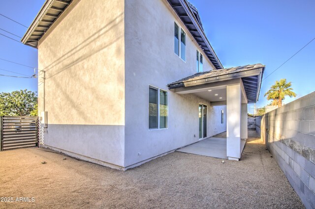 5945 W Lamar Rd, Glendale, AZ 85301 - back of house featuring a fenced backyard, a patio, and stucco siding
