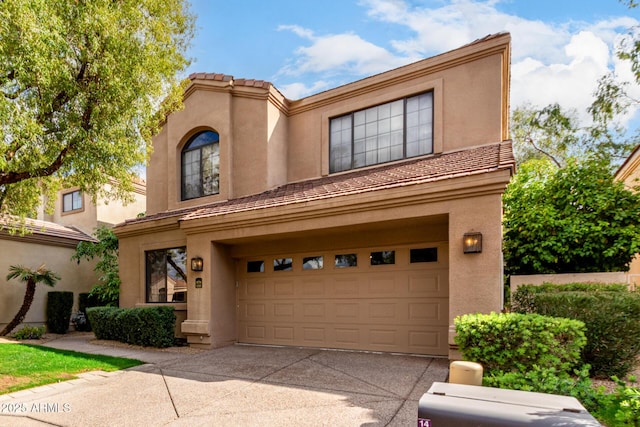 view of front of property featuring a garage, concrete driveway, and stucco siding