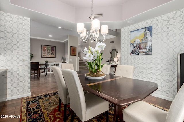 dining room featuring stairs, baseboards, and wood finished floors