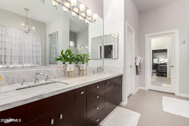 full bath with a sink, ensuite bath, a chandelier, and double vanity