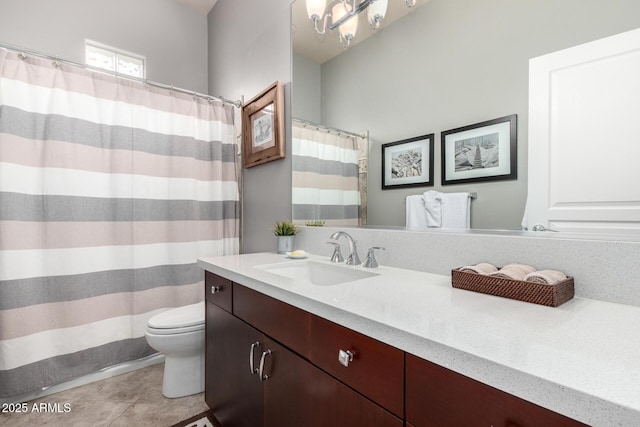 full bathroom with vanity, tile patterned floors, curtained shower, and toilet