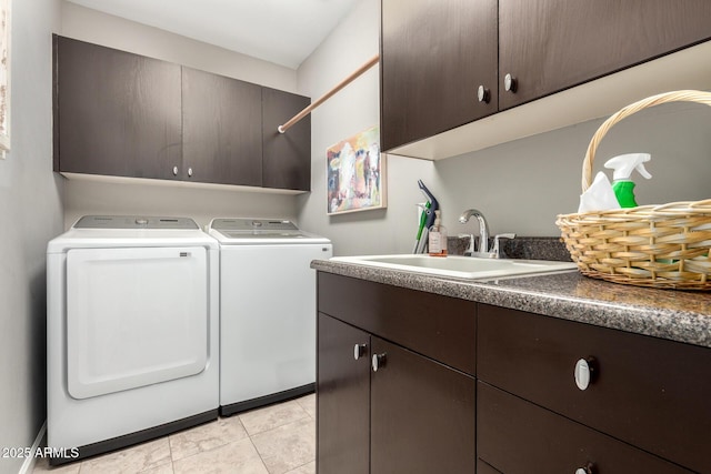 laundry room with separate washer and dryer, light tile patterned flooring, cabinet space, and a sink