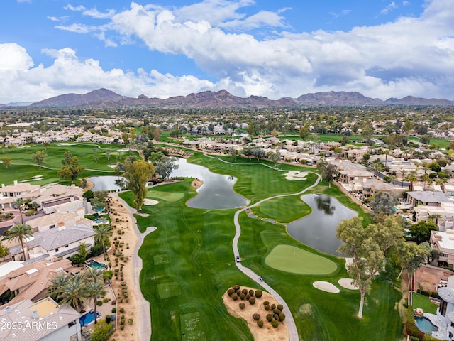 aerial view with a residential view, a water and mountain view, and view of golf course