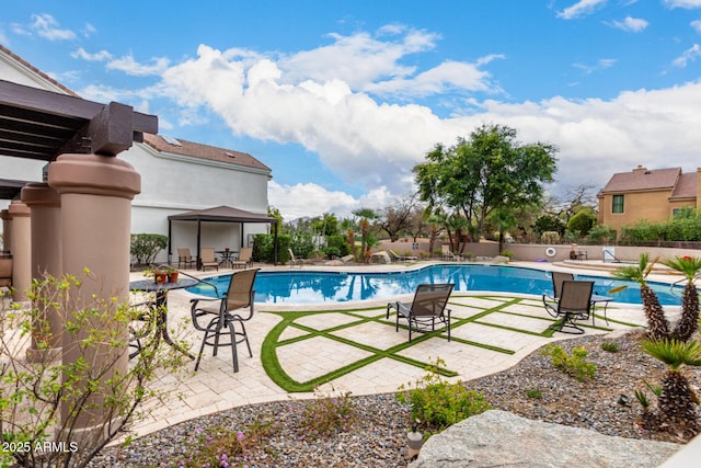 pool featuring fence and a patio area