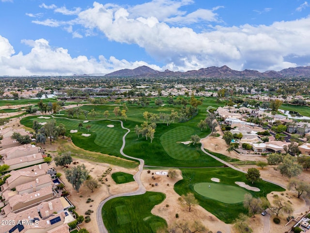 birds eye view of property with view of golf course, a mountain view, and a residential view