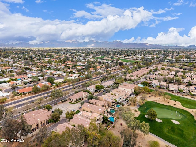 drone / aerial view featuring a mountain view, a residential view, and view of golf course