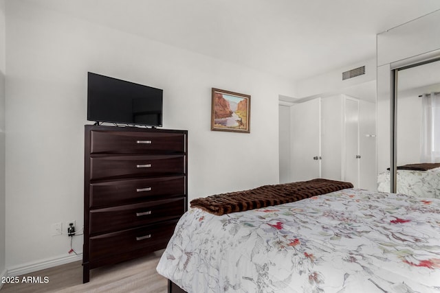 bedroom with a closet and light wood-type flooring