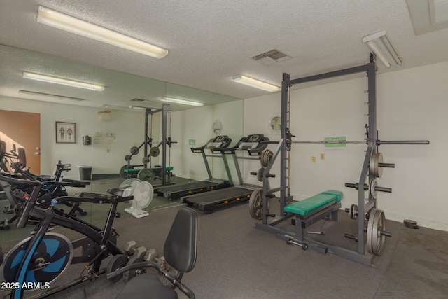 gym with a textured ceiling