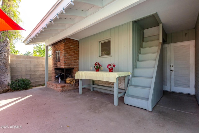 view of patio with an outdoor brick fireplace