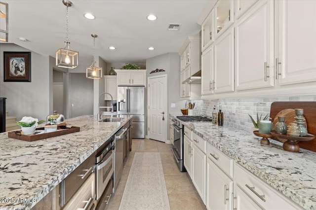 kitchen featuring white cabinetry, premium appliances, and sink