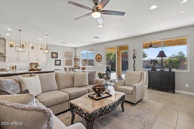 tiled living room featuring ceiling fan