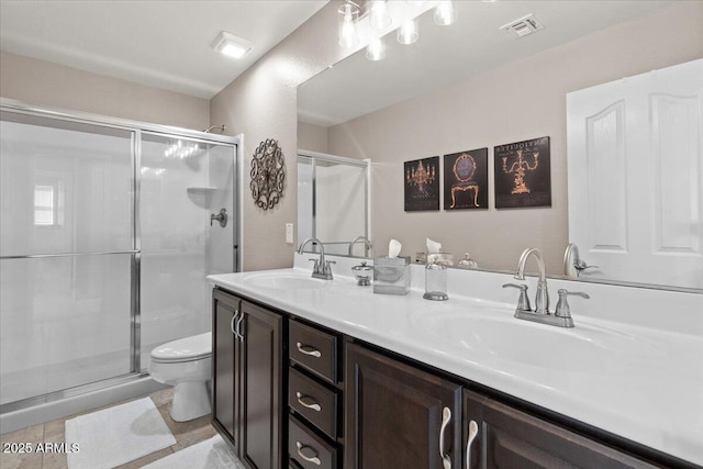 bathroom with vanity, walk in shower, and toilet