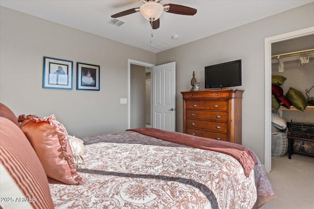 carpeted bedroom with ceiling fan and a closet