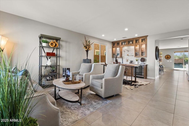 living room featuring wine cooler and light tile patterned floors