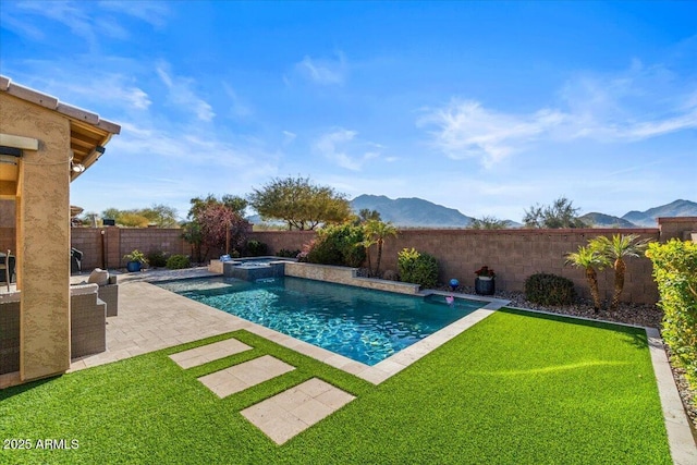 view of swimming pool featuring a mountain view, a lawn, a patio, and an in ground hot tub