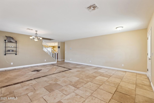 12748 N 57th Dr, Glendale, AZ 85304 - unfurnished room with a chandelier, baseboards, stairway, and stone finish flooring
