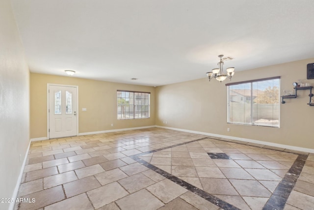 12748 N 57th Dr, Glendale, AZ 85304 - entryway featuring inlaid floor details, a chandelier, and baseboards