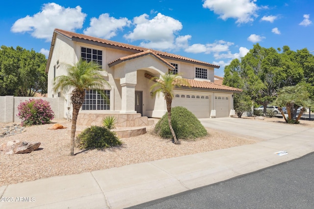 12748 N 57th Dr, Glendale, AZ 85304 - mediterranean / spanish-style house featuring stucco siding, fence, a tile roof, and concrete driveway