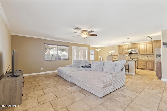 12748 N 57th Dr, Glendale, AZ 85304 - living area featuring a ceiling fan, crown molding, baseboards, light stone finish floors, and a chandelier