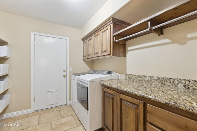 12748 N 57th Dr, Glendale, AZ 85304 - laundry area with washer and dryer, stone tile flooring, cabinet space, and baseboards