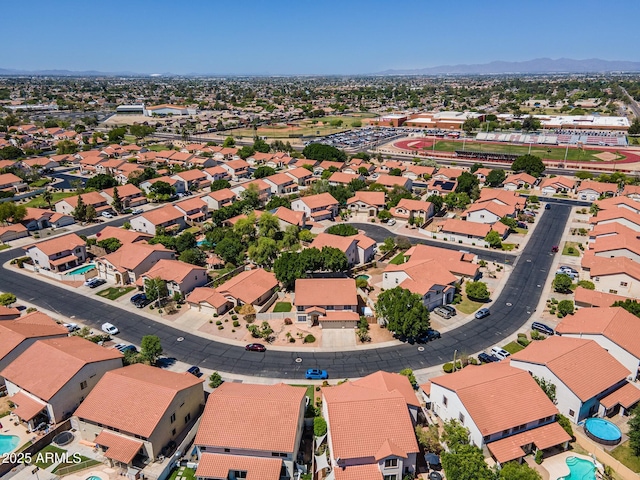 12748 N 57th Dr, Glendale, AZ 85304 - aerial perspective of suburban area with a pool area and a mountain backdrop