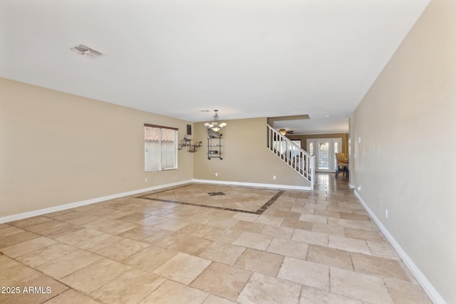 12748 N 57th Dr, Glendale, AZ 85304 - spare room featuring stairs, a chandelier, and baseboards